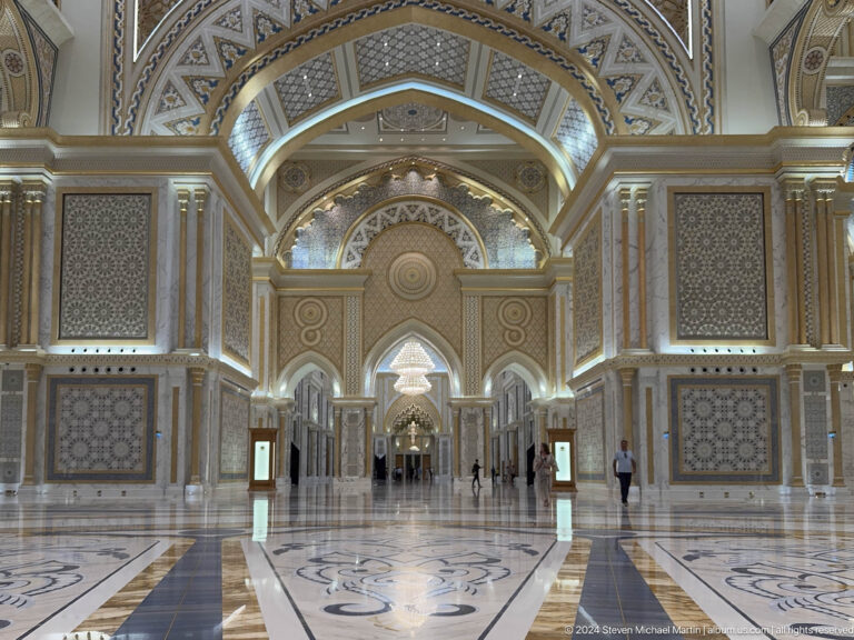 Long axial view through grand palace arches.