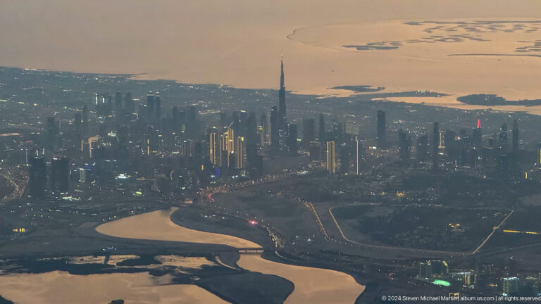 Burj Khalifa rising above Dubai’s skyline beyond water channels.