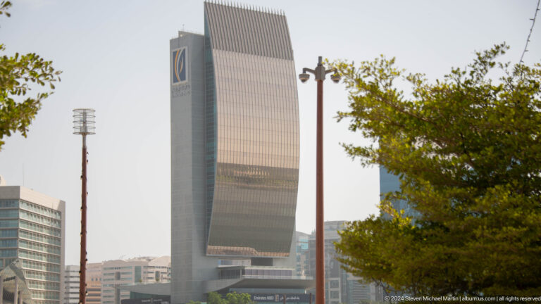 Dubai high-rise with a large arched opening at the top.