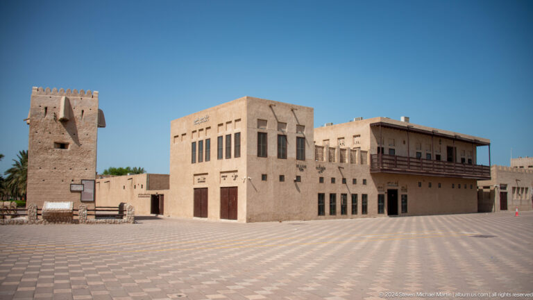 Wide plaza surrounded by restored traditional buildings in Dubai.
