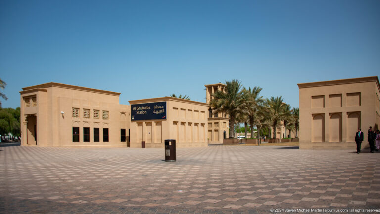 Open plaza with restored heritage buildings and palm trees in Al Shindagha.