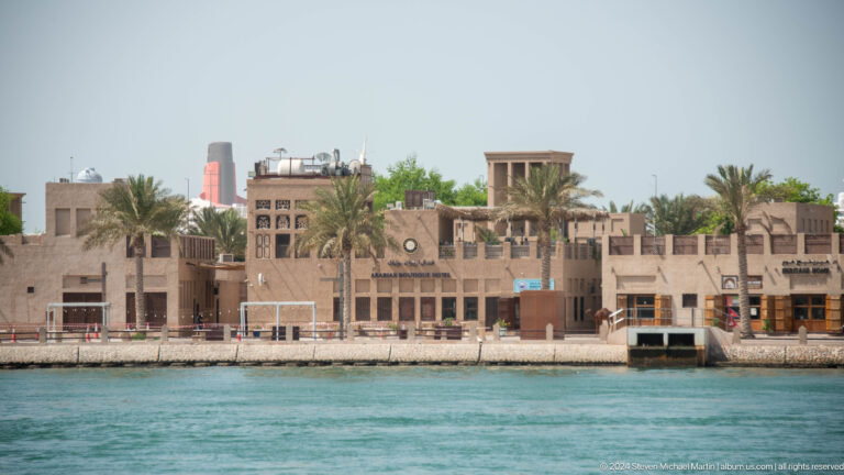 Traditional wind-tower buildings lining the far side of Dubai Creek.