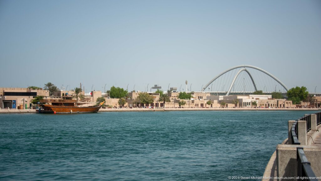 Wide view across Dubai Creek toward Infinity Bridge.