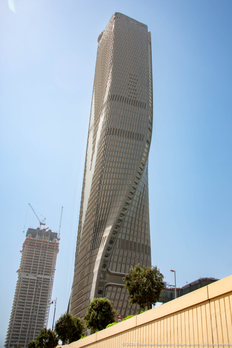 Curving Dubai tower covered with dense vertical fins.