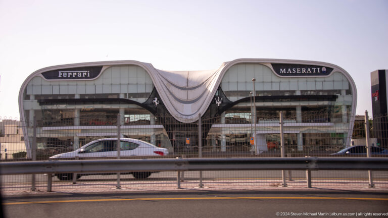 Elevated Dubai Metro station with a flowing white canopy.