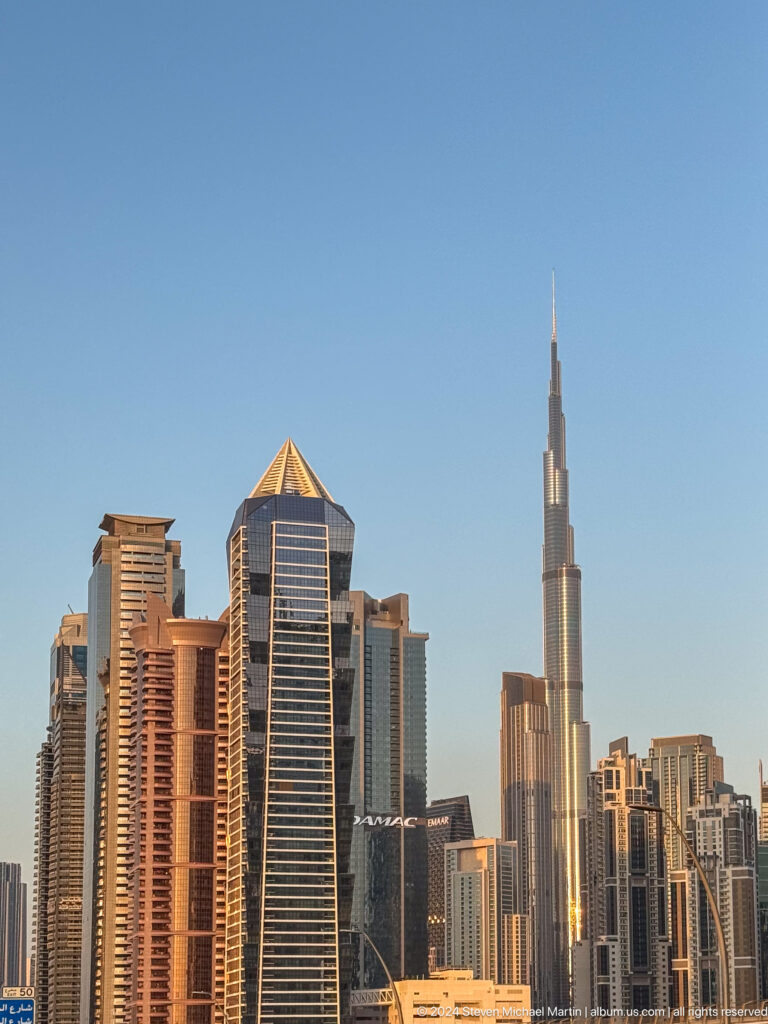 Burj Khalifa rising beside a cluster of modern Dubai towers.
