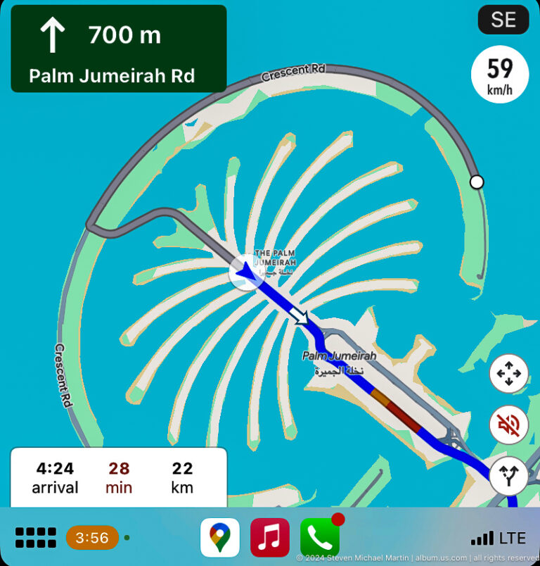 Digital navigation map showing Palm Jumeirah's trunk, fronds, crescent, and route line.