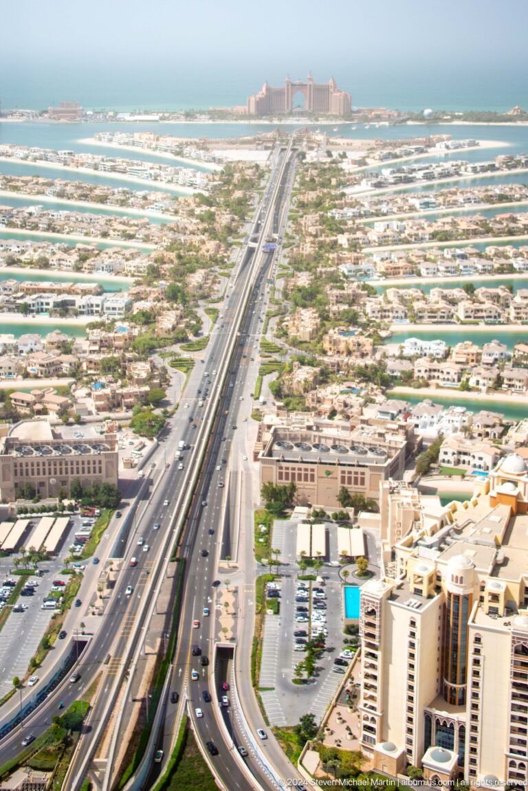 High-angle view of Palm Jumeirah's highway and monorail corridor between villa districts.