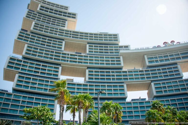 Atlantis The Royal's stacked hotel wings rising above palm trees and gardens.