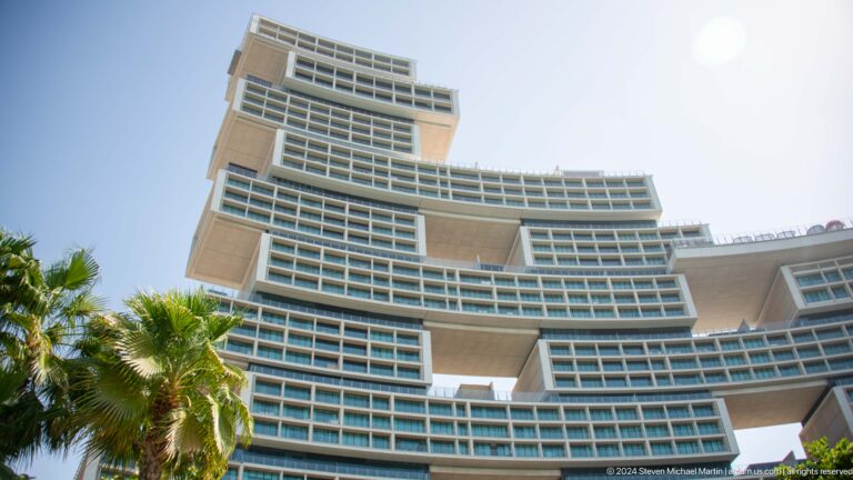 Close upward view of Atlantis The Royal's curved stacked balconies and deep overhangs.