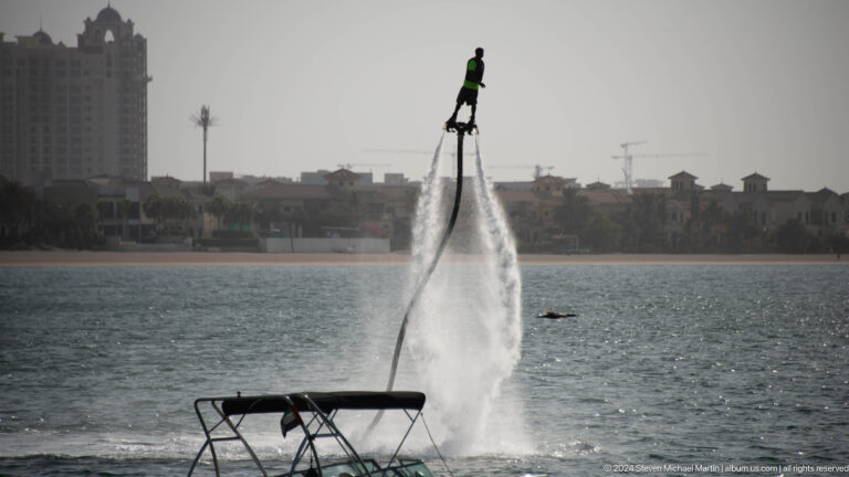 Flyboard rider lifted above the sea by water jets near Palm Jumeirah.