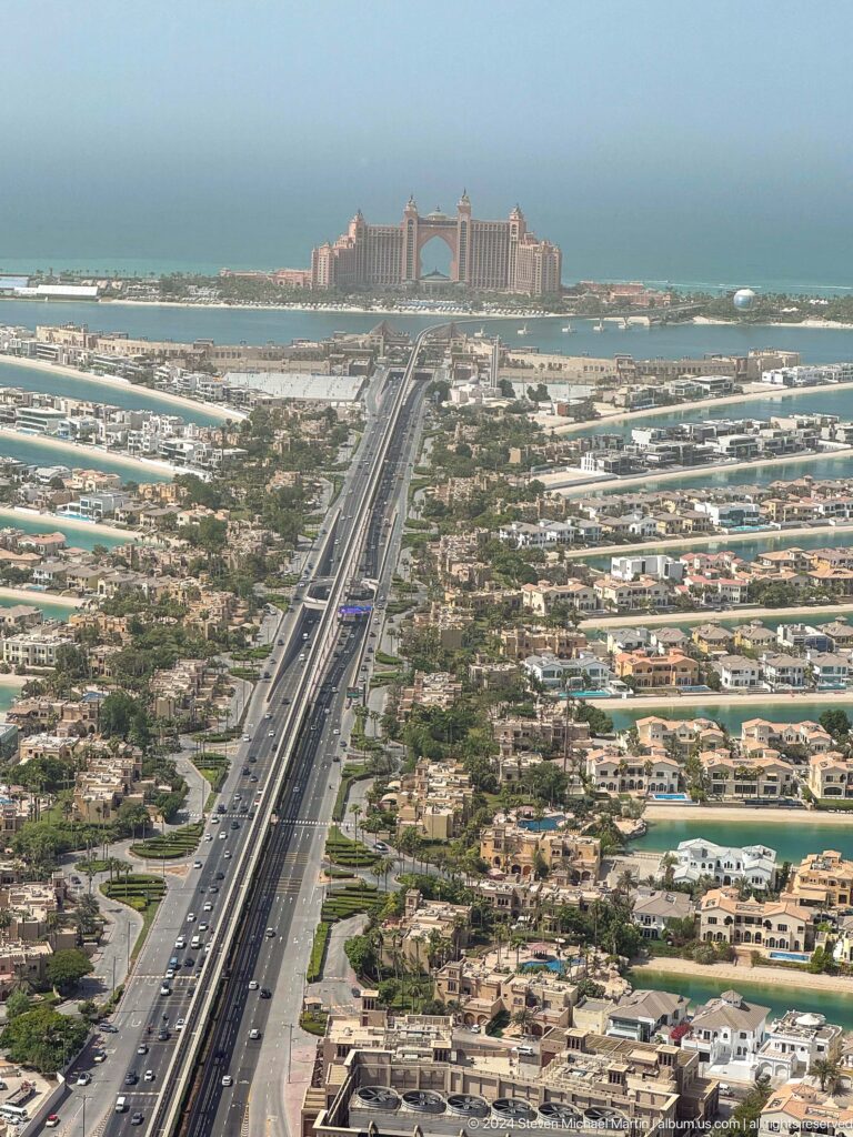 Palm Jumeirah highway and monorail running between dense villa-lined fronds.