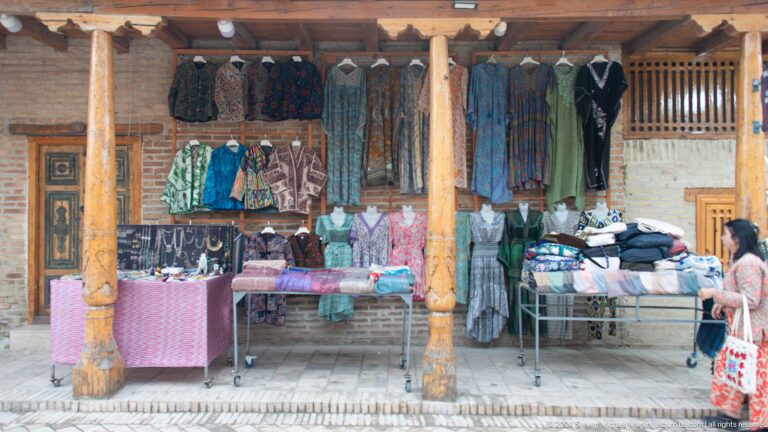 Market stall displaying clothing and textiles.