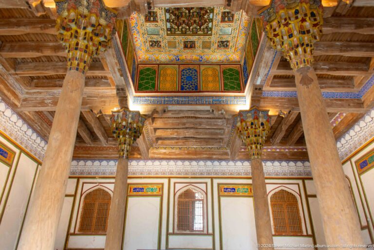 Painted wooden ceiling and carved columns.