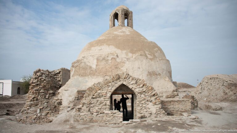 Ruined brick dome with open arch.