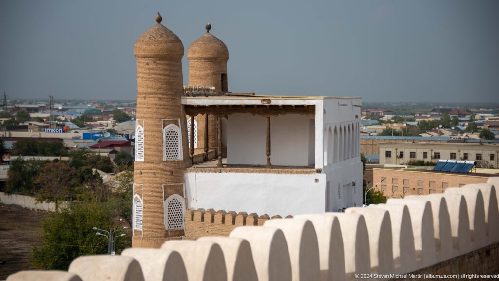 Small watchtower and parapet above city.
