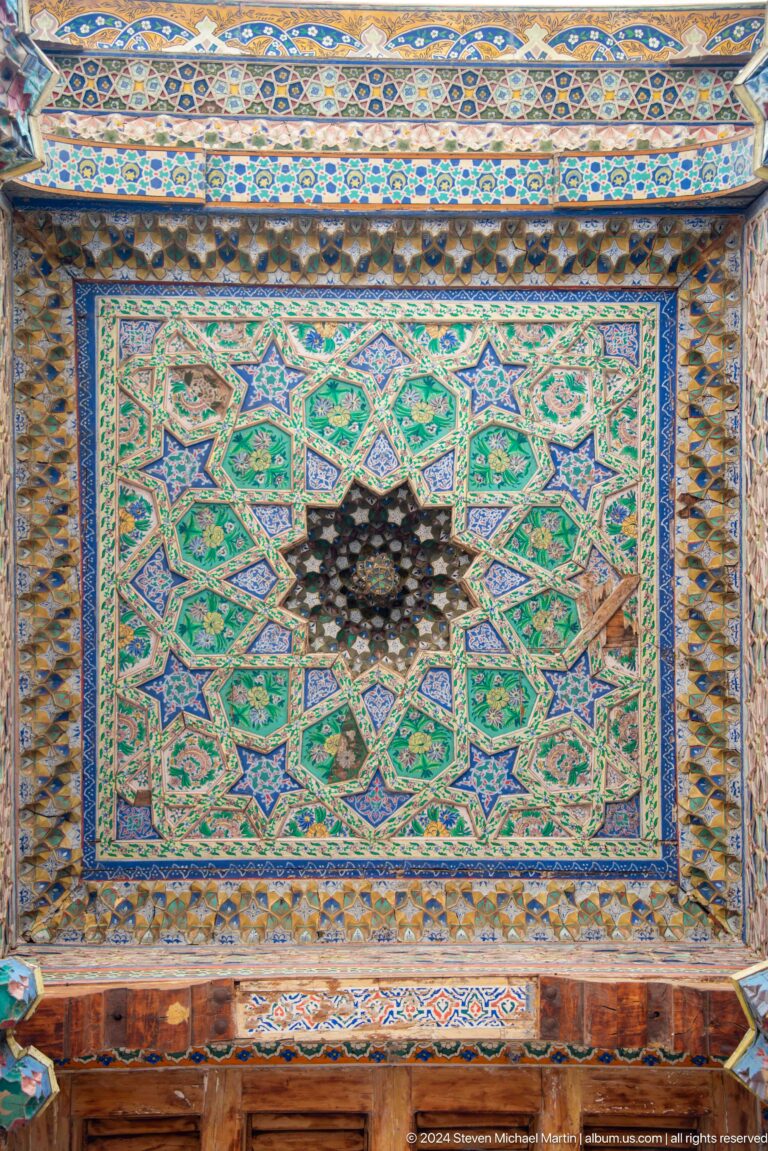 Turquoise star-pattern ceiling panel centered on a dark rosette.