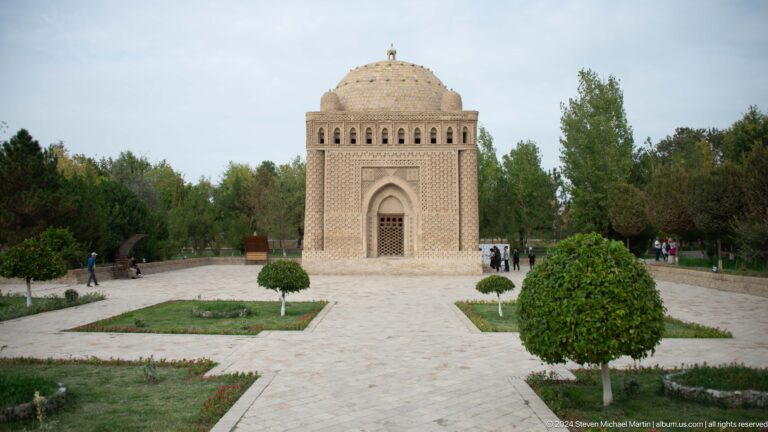Samanid Mausoleum centered at the end of a landscaped garden path.