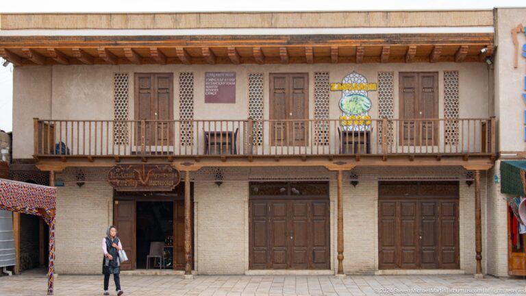 Two-story timber balcony facade.
