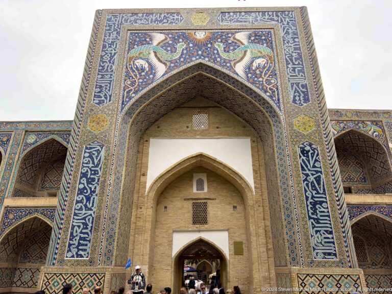 Tall tiled entrance portal with calligraphic borders at the Ulugh Beg Madrasa.