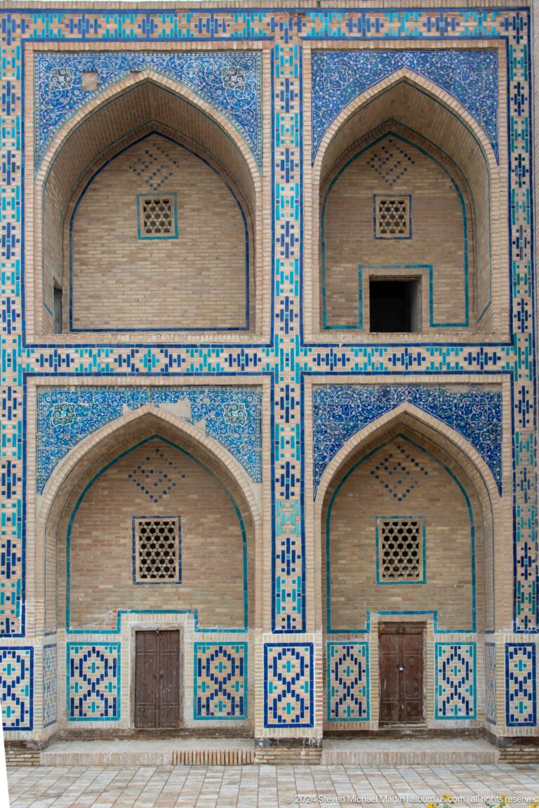 Paired arched niches framed by blue tile.