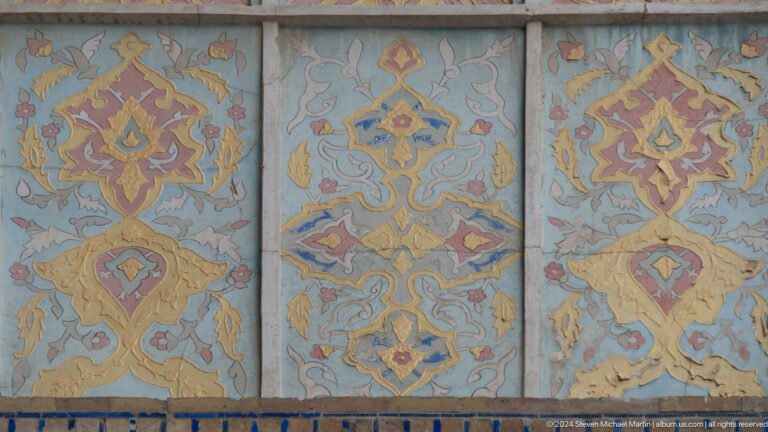 Faded geometric painted ceiling panels.
