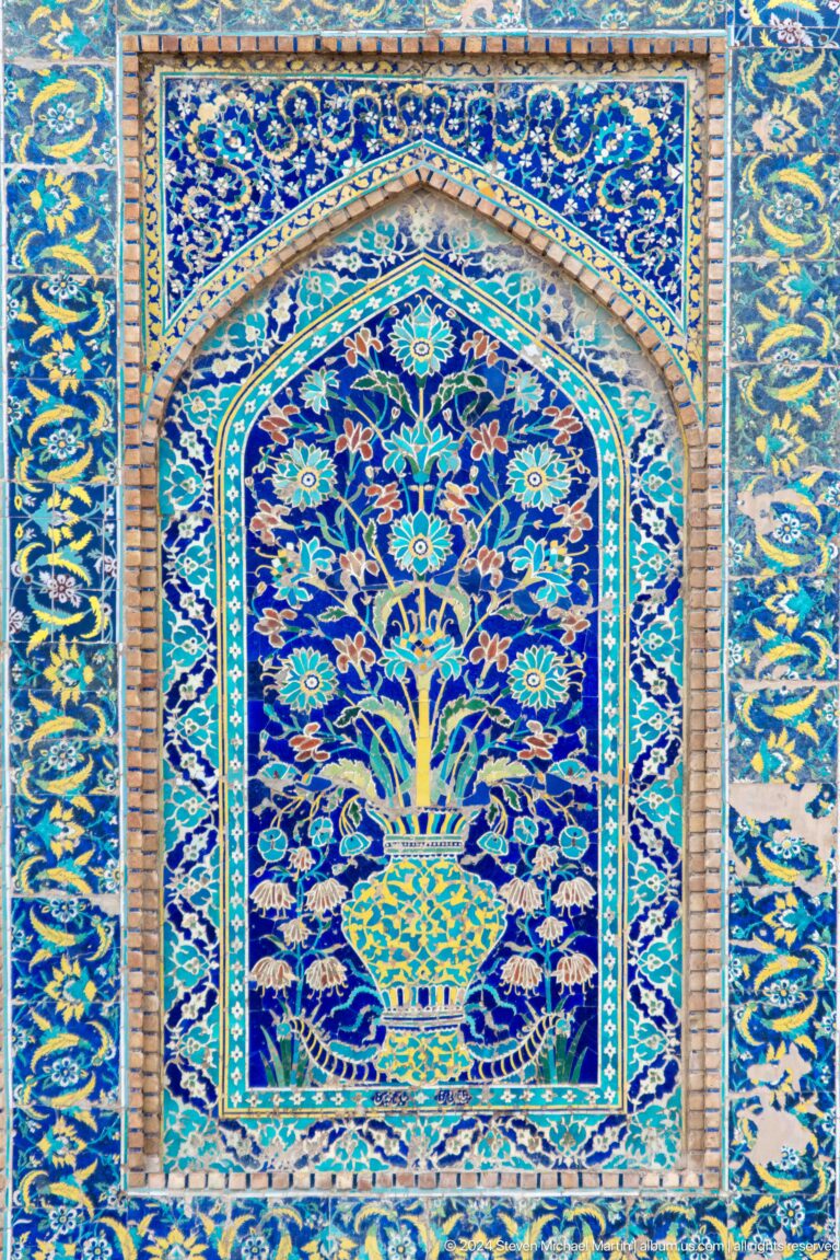 Bright blue floral ceramic panel.