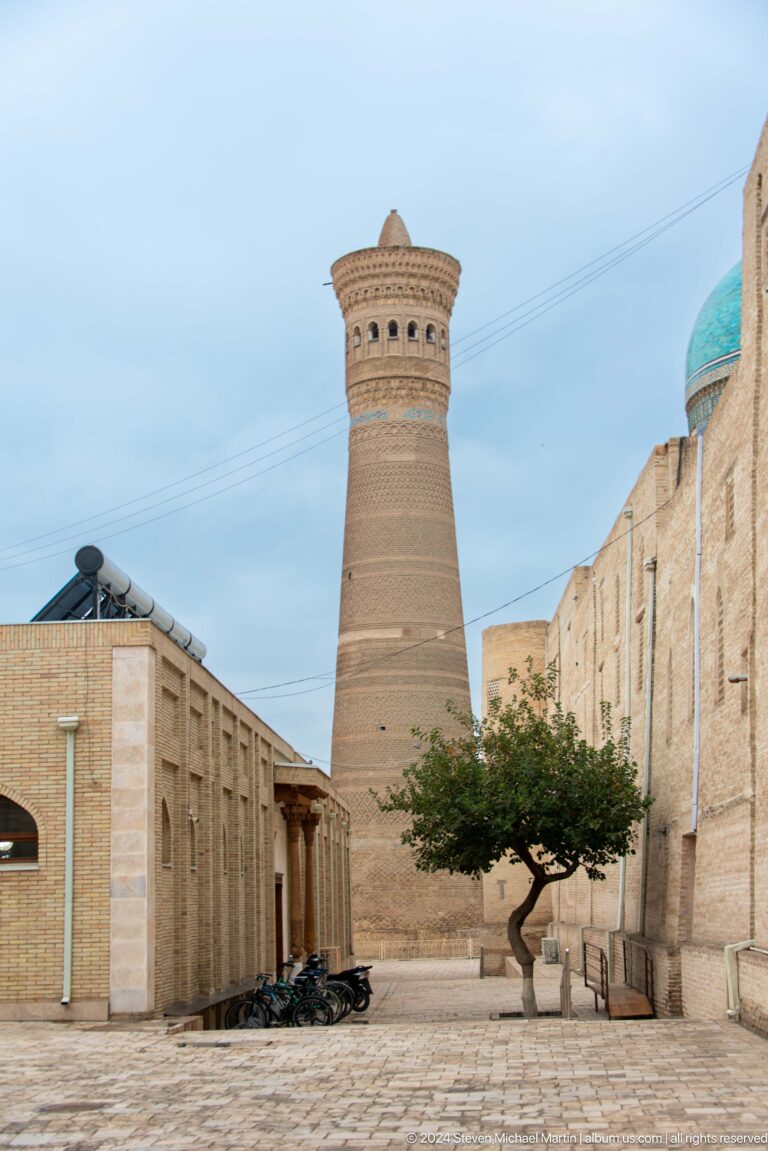 Kalyan Minaret between high brick walls.