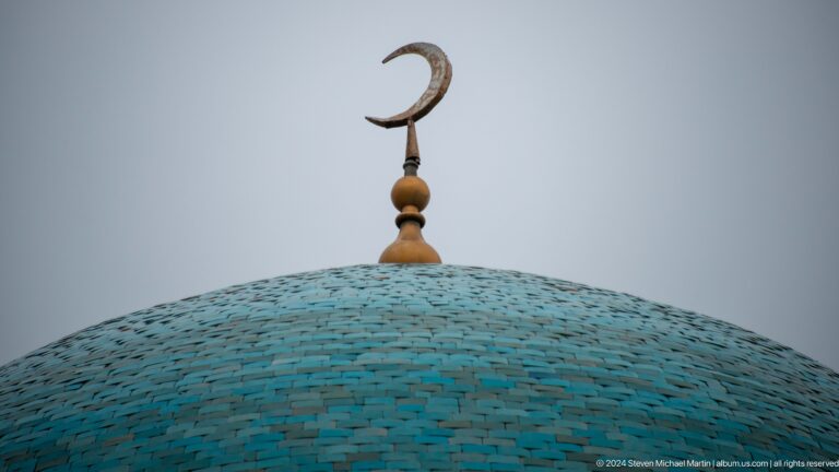 Crescent finial atop turquoise dome.