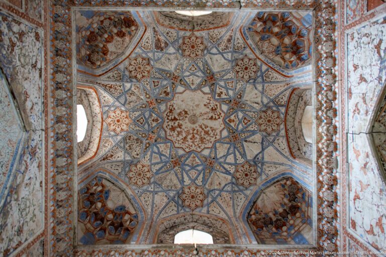 Painted star-pattern ceiling with arched openings.