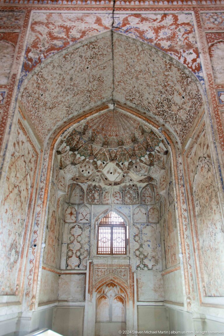 Faded painted vault with geometric cells.