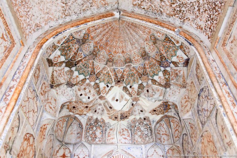 Ornate vault with central rosette and faded murals.