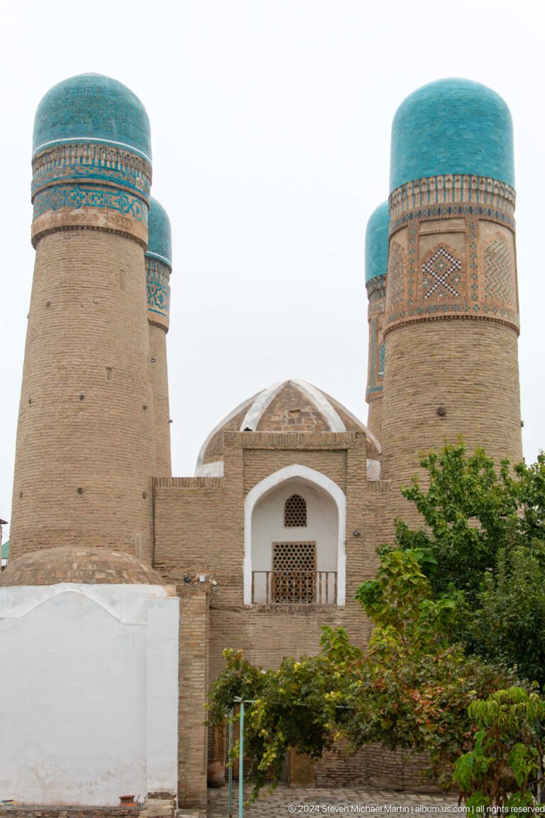 Chor Minor towers partly hidden by trees.