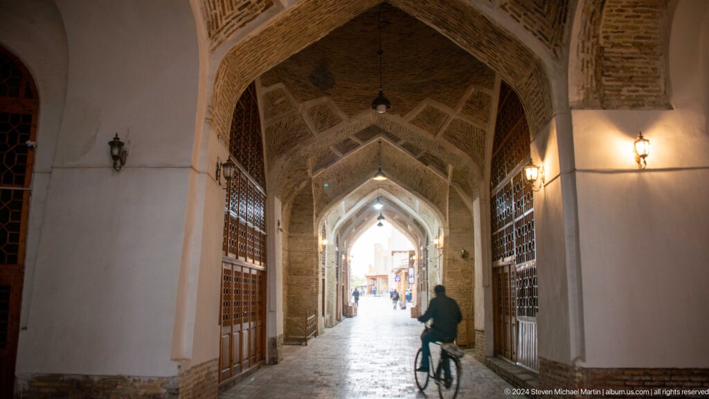 Long vaulted bazaar corridor with bicycle rider.