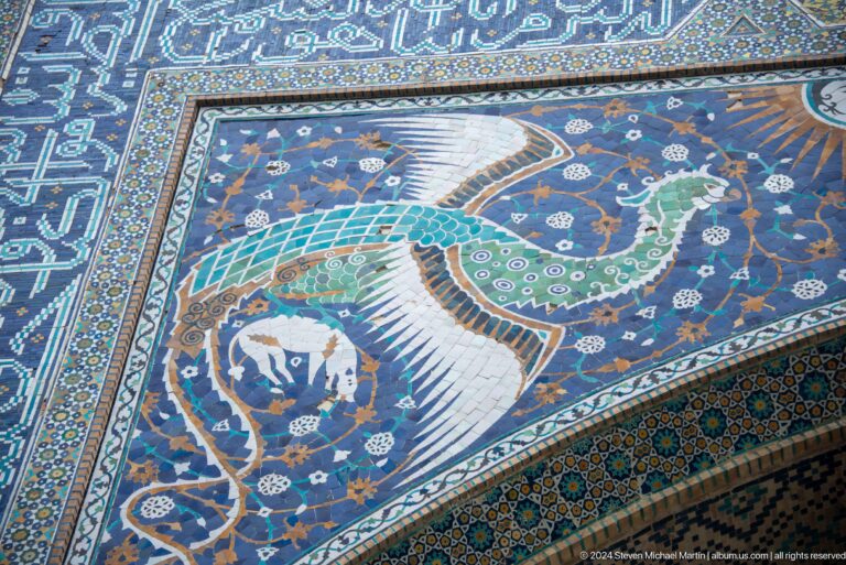 Mosaic panel depicting bird among flowers.