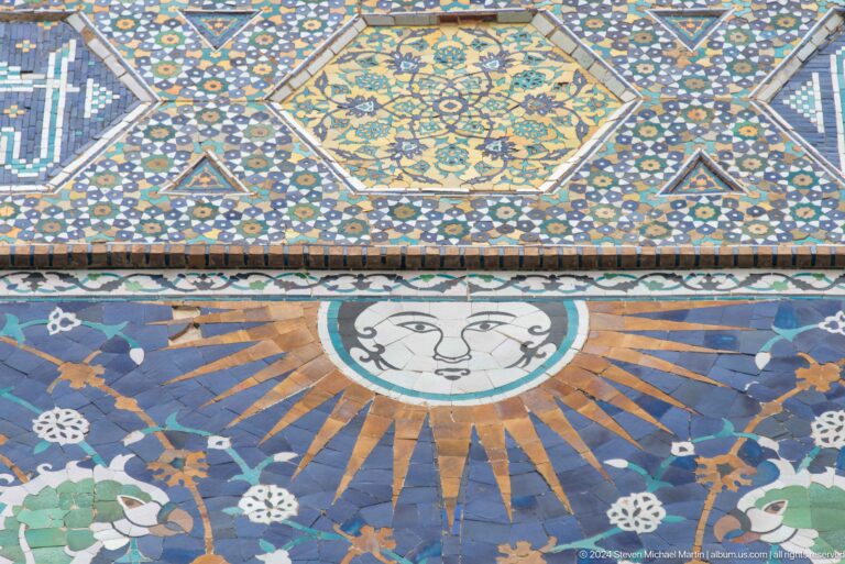 Sun-face medallion in geometric tilework.