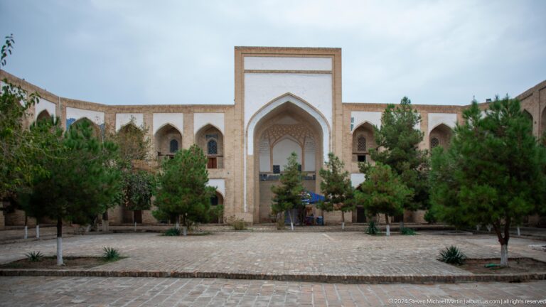 Courtyard entrance framed by trees.