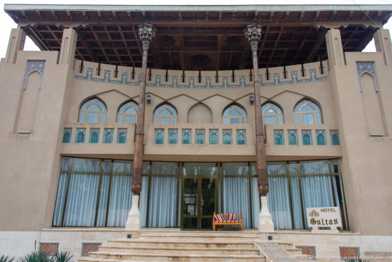 Timber-columned facade with blue shutters.