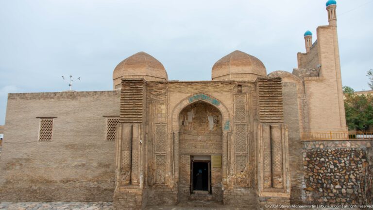 Brick mausoleum facade with arched doorway.