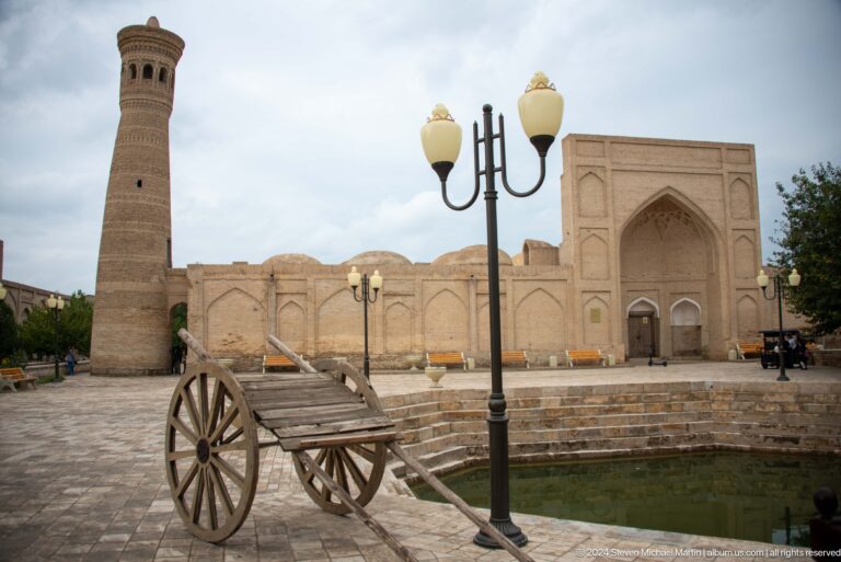 Wooden cart and lamp posts before minaret.