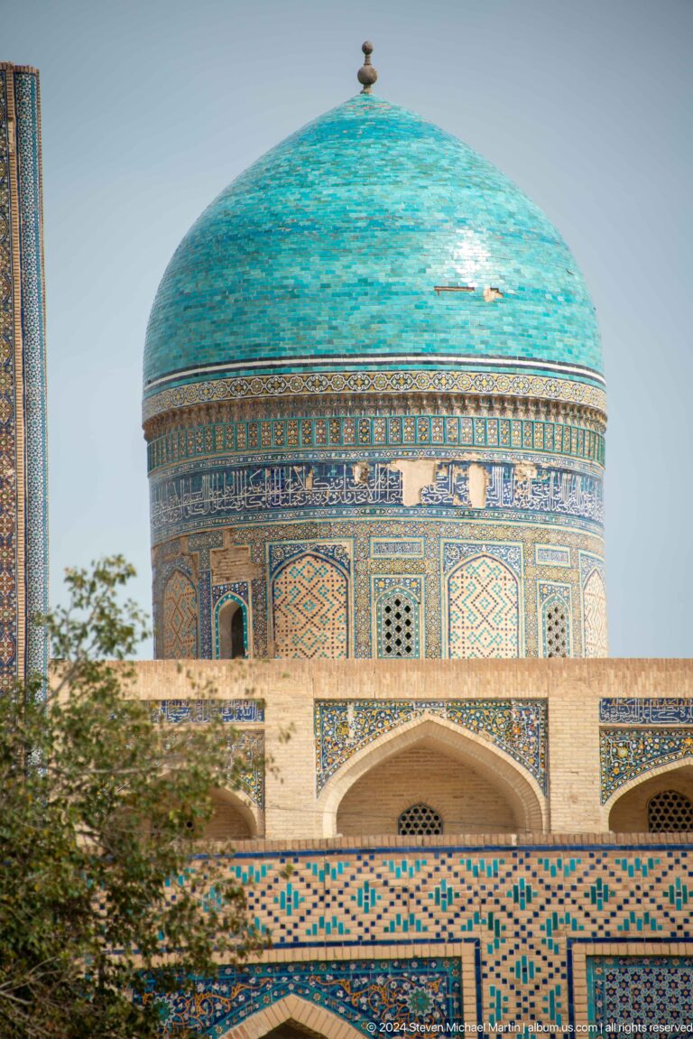 Turquoise dome covered in tile patterns.