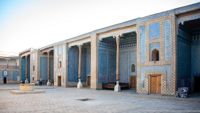 Long colonnaded palace facade with blue tiles.