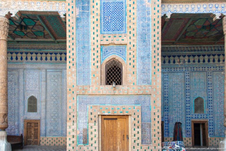 Blue-tiled facade with central door and lattice window.
