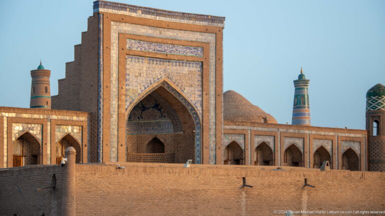Monumental tiled portal viewed above a defensive wall.
