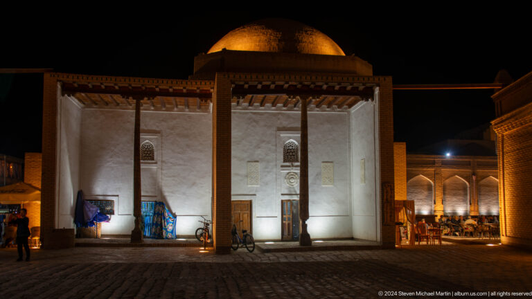 Small pavilion-like building illuminated at night.
