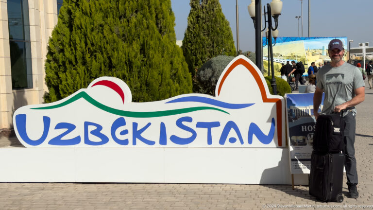 Uzbekistan tourism sign in public square.