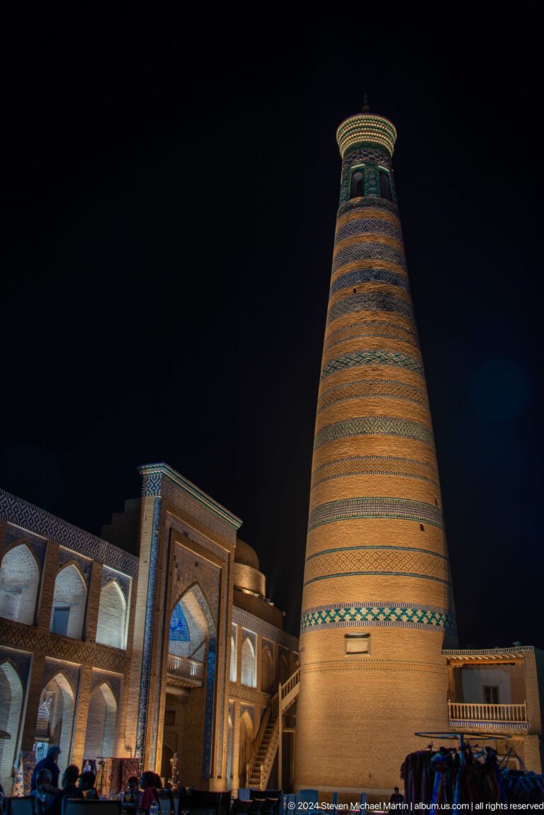 Islam khoja minaret illuminated against black sky.
