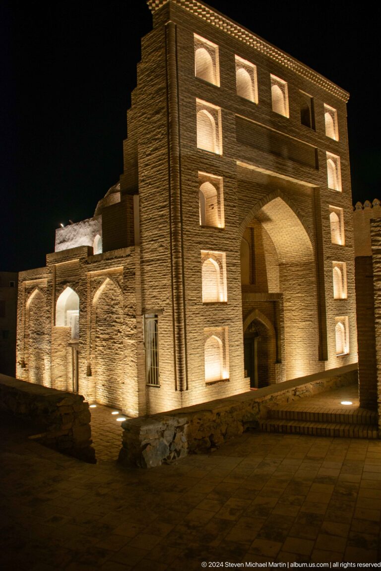 Illuminated brick portal and arcade.