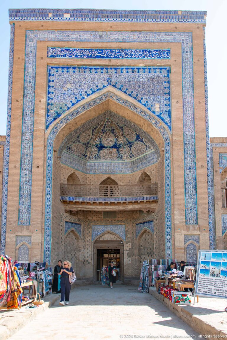 Deep pointed portal covered in blue tilework.