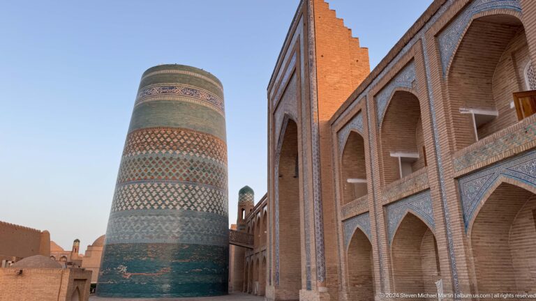 Kalta minor and madrasa facade in warm daylight.